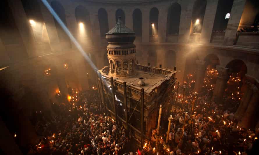 Christian pilgrims hold candles at Jerusalem's Church of the Holy Sepulchre, traditionally believed to be the burial site of Jesus Christ.