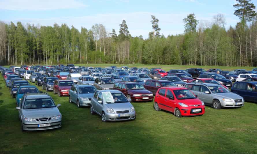 Cars line up for a game of drive-in bingo in a Swedish field.