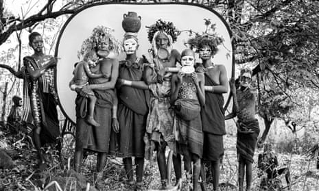 A group of Suri women with lip plates, headdresses and body paint