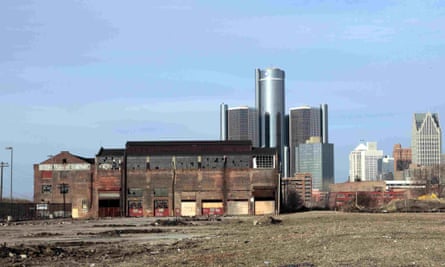 The Renaissance Center shines behind a dilapidated Detroit warehouse in 2009.