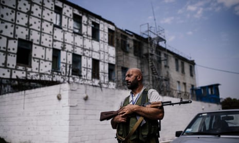 A rebel gunmen patrols a high-security prison after shelling in Donetsk in 2014. Ukraine