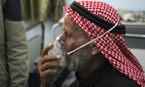 A man breathes through an oxygen mask after an alleged chlorine gas attack in Idlib