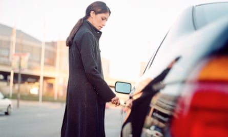 woman locking a car