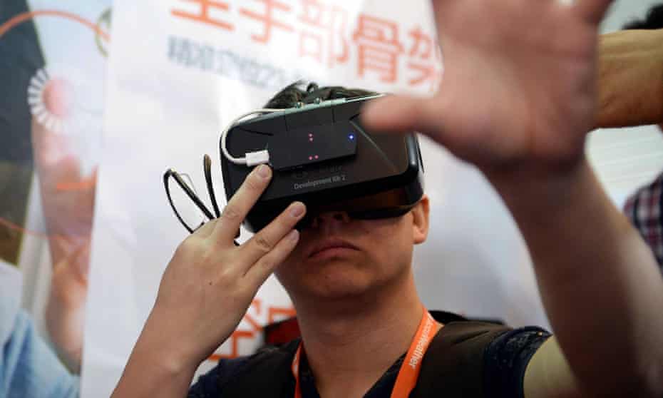 A visitor tries the Oculus Rift Development Kit 2 at the first Consumer Electronics Show in Asia, in Shanghai on Tuesday.