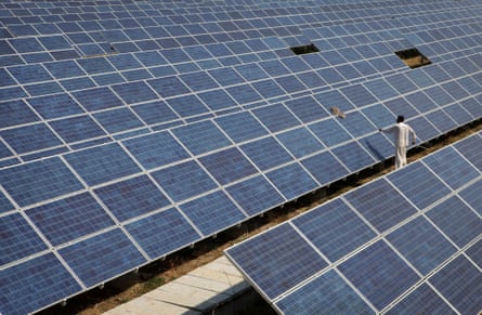 A worker cleans solar panels at the Azure Solar Plant in Gujarat, India.