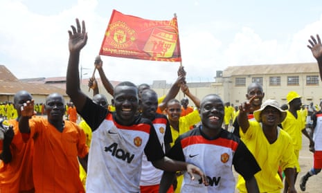 Manchester United members celebrate their 3-1 victory over Liverpool 3-1 in annual Radio Simba football tournament at Luzira maximum prison in Kampala.