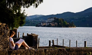 Young woman student reading by Lake Orta at San Giulio