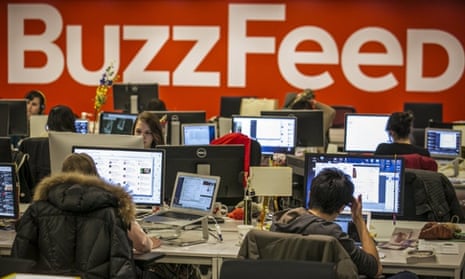 The BuzzFeed logo is displayed on the wall as employees work in the newsroom at the company's headquarters in New York.