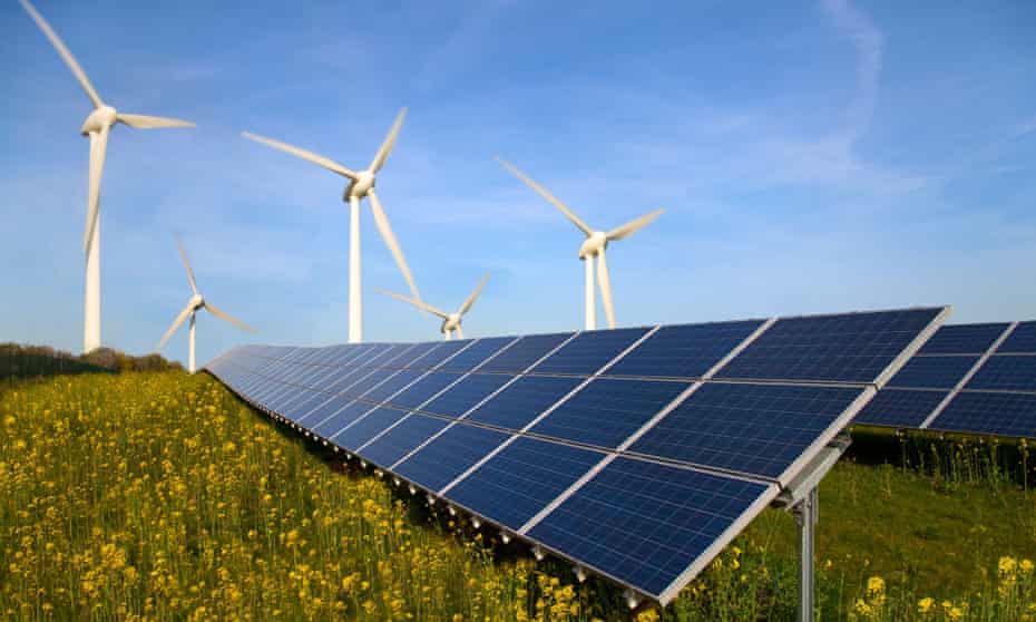 Solar panels and wind turbines in a field