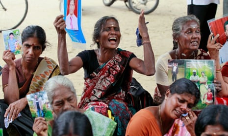 Sri Lankan ethnic Tamil women hold portraits of missing relatives during a protest in Jaffna, Sri Lanka, in 2013.