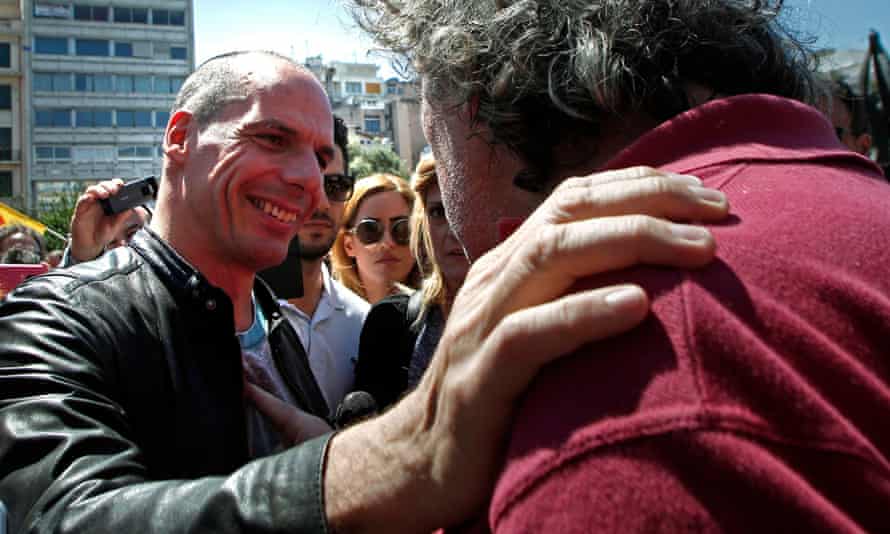Greek finance minister Yanis Varoufakis talks with a protester in a demonstration during a May Day rally. He continues to enjoy widespread support, despite a lack of progress from Syriza.