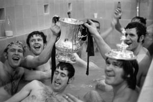 Chelsea players celebrate in the bath at Old Trafford, after finally beating Leeds 2-1 in the replay. Holding the trophy are John Hollins, left, and Peter Osgood (who scored Chelsea’s first goal). In the foreground are, left to right, Tommy Baldwin, Peter Bonetti and David Webb (who scored the second) wearing the lid