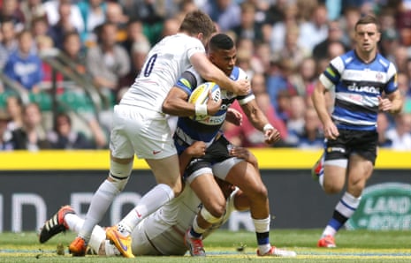 Anthony Watson of Bath Rugby is tackled by Owen Farrell of Saracens.