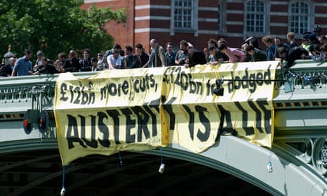 Demonstrators display a banner on Westminster Bridge as they participate in a protest against the British Government's planned austerity measures in central London