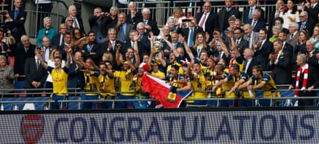 Arsenal celebrate with the trophy.