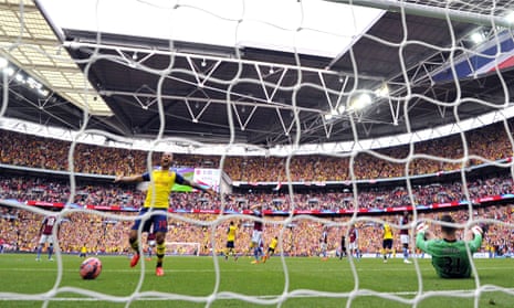 Arsenal's Theo Walcott celebrates team-mate Alexis Sánchez's long-distance goal against Aston Villa