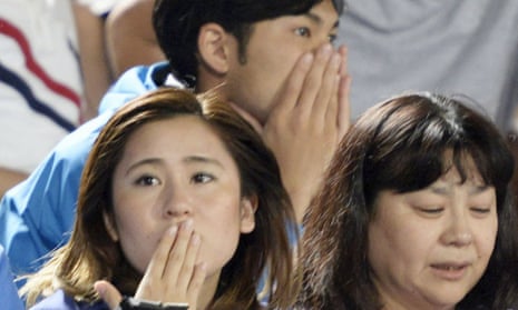Soccer fans react to a strong earthquake in Japan