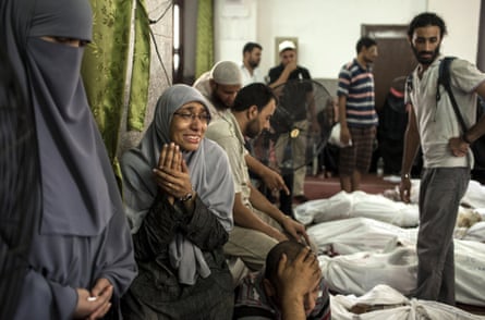An Egyptian woman identifies the body of a family member, a supporter of deposed Egyptian President Mohammed Morsi killed during a violent crackdown by Egyptian Security Forces on pro-Morsi sit-in demonstrations the day before, at the al-Iman Mosque in Nasr City on August 15, 2013 in Cairo, Egypt.