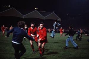 1975-76 Liverpool's Ian Callaghan, right, and Tommy Smith are joined on the pitch by equally jubilant supporters after Liverpool's 3-1 win at Molineaux in the last game of the season.  The victory meant Liverpool won the title for the ninth time in the club's history and the first time under manager Bob Paisley