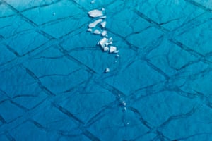 These are shards of ice that are floating in a large unnamed seasonal meltwater lake atop the Sermeq Kujalleq, or Jakobshavn Glacier, about 60km east of Ilulissat, Greenland, during August, 2014.

Greenland is no longer a terrain of pure and infinite glacial white. Melting during the summer season now reveals it to be a place increasingly marred with impact from climate change, such as this large expanse of blue water, as beautiful as it may be. This is not merely a local impact, as the Danish Meteorlogical Institute estimated that the 2014 summer melt season of Greenlandic Ice was responsible for a 1.2mm rise of sea level around the globe.