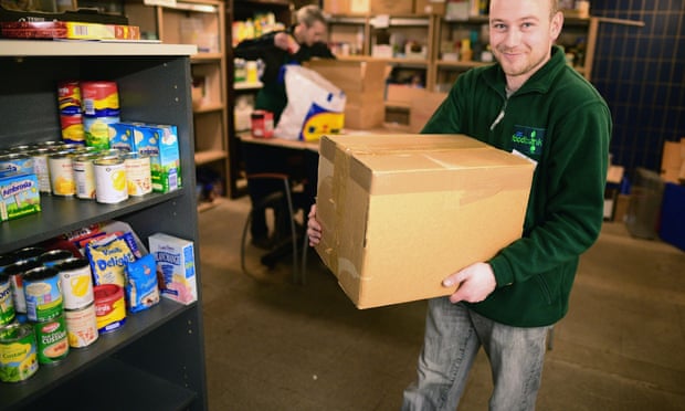 Michael Spence a volunteer packs food at a food bank  in Whitburn, Scotland.