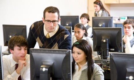 A teacher with pupils in a computer room