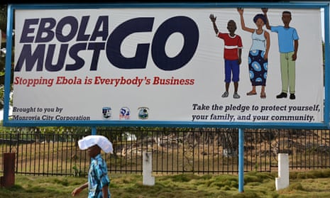 A man walks past an ebola campaign banne