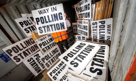 a council official sorts through polling signs and booths in Devon, in preparation for the General Election on the 7th May 2015.