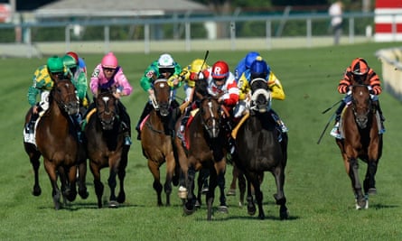 The Apache, ridden by Christophe Soumillon (10), impedes Real Solution, center, ridden by Alan Garcia, as they run toward the finish during the Arlington Million horse race on Saturday, Aug. 17, 2013, in Arlington Heights, Ill. The Apache was disqualified for the foul and Real Solution was ruled the winner.  (AP Photo/Brian Kersey)