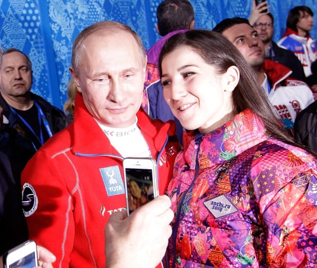 Vladimir Putin poses with a fan 