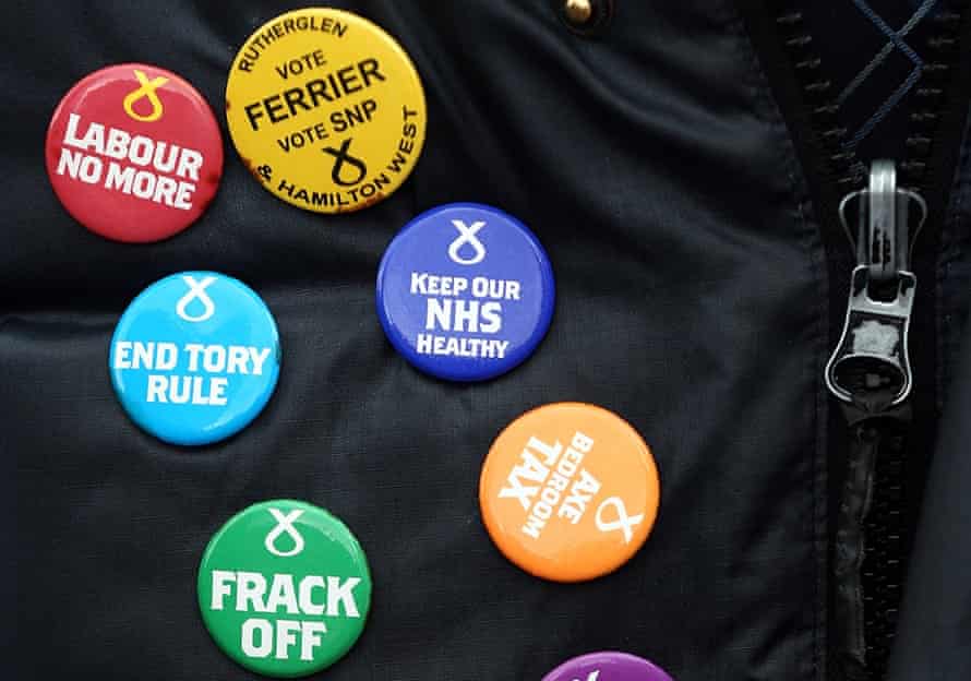 The badges of a Scottish National Party supporter.