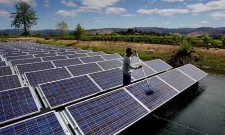 Elbin Blatz washes off one of 994 panels in the floating solar cell array at Far Niente winery in Oakville, California