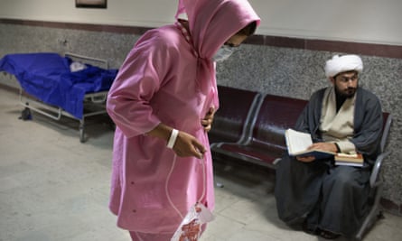 Narin, walking in the hallway of the hospital where two days earlier she had a kidney removed. Besides her and her husband, no other members of her family know of her decision to sell her organ.