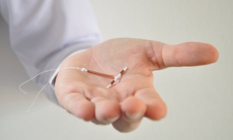 hand holding an IUD