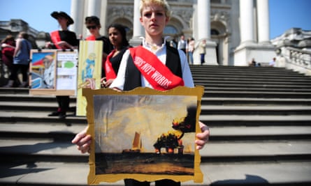 A Climate Rush Activists holds a painting of the Deepwater Horizon disaster outside the Tate Britain in protest over sponsorship of the Tate museums by BP, 20 April 2011.