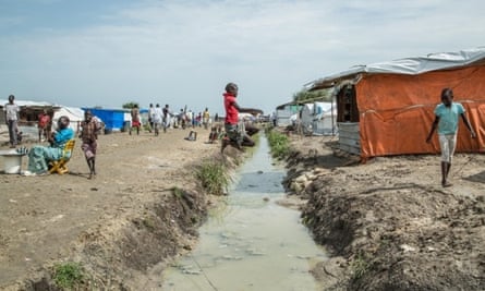 Child jumps a drainage ditch in Malakal POC, Upper Nile