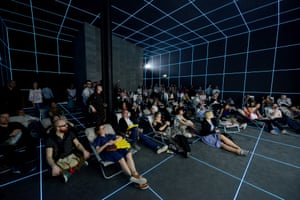 German Pavillion. Audience looking at the video installation by Hito Steyerl, Factory of the Sun, 2015. Video installation: One-channel video