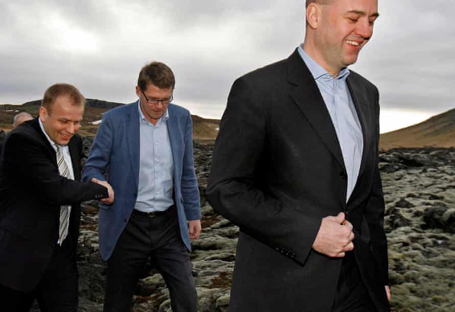 Faroe Islands prime minister Kaj Leo Johannesen, left, shakes hands with Finnish PM Matti Vanhanen, as they follow Sweden's prime minister Fredrik Reinfeld, prior to the 2009 Nordic prime minister's meeting in Eldborg, Iceland,