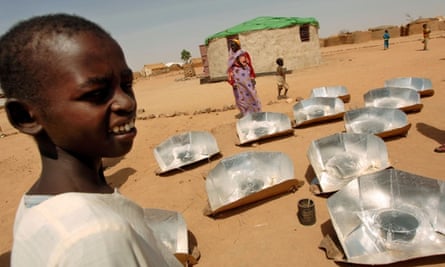 Sudanese refugees stand around solar stoves during a training session in Iridimi camp, north-eastern Chad