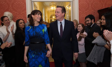 David Cameron and his wife Samantha are applauded by staff on entering 10 Downing Street.