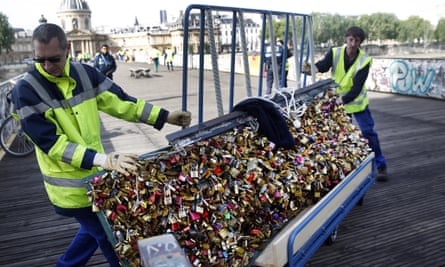City municipal employees remove the barriers with love padlocks on the Pont des Arts.