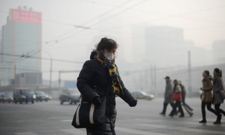 A woman wearing a face mask to protect against smog in Beijing in January 2014.