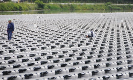 Engineers at work at a floating solar power plant in Hyogo Prefecture, western Japan. 