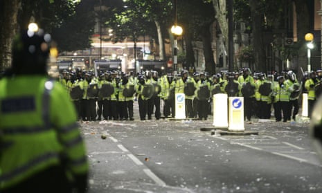 Police are seen in Ladbroke Grove, London, as trouble breaks out during the Notting Hill Carnival