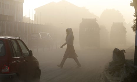 A Kashmiri woman covers her face as she crosses a dusty road in Srinagar, India. The WHO puts 13 Indian cities in the world’s 20 most polluted, with Delhi deemed the filthiest.