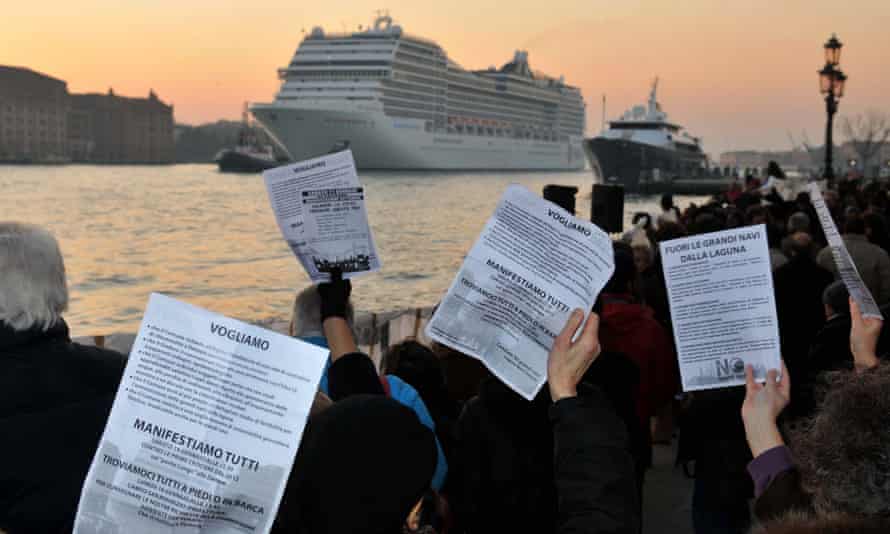 People take part in a demonstration against the negative environmental impact of cruise ships passing and mooring in the lagoon of Venice in 2012