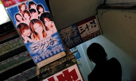 A man enters a strip club in central Tokyo.