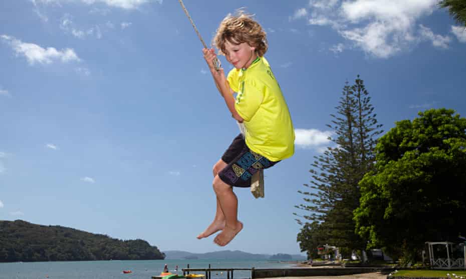 Young boy on rope swing