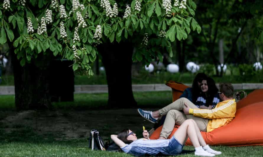Young people resting under a tree in Gorky Park.