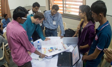 Participants at a Kumbathon workshop talk MIT's John Werner through their idea